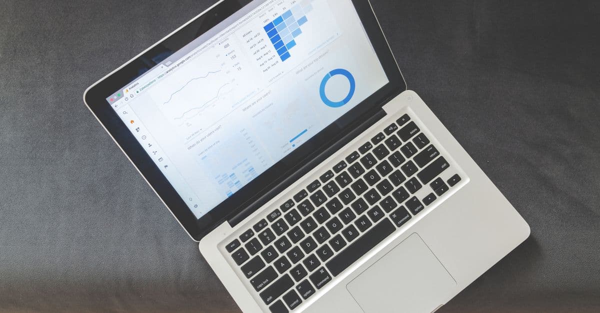 A software dashboard with analytics charts on a laptop screen