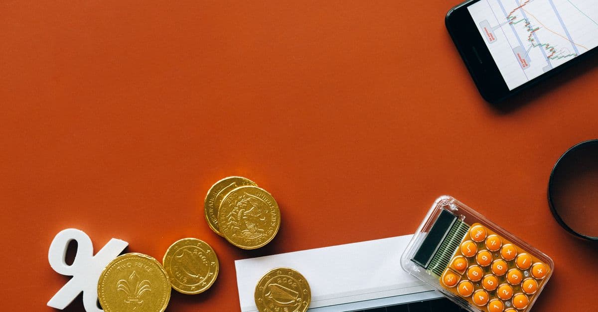 Coins and a financial graph illustrating an interest rate calculation