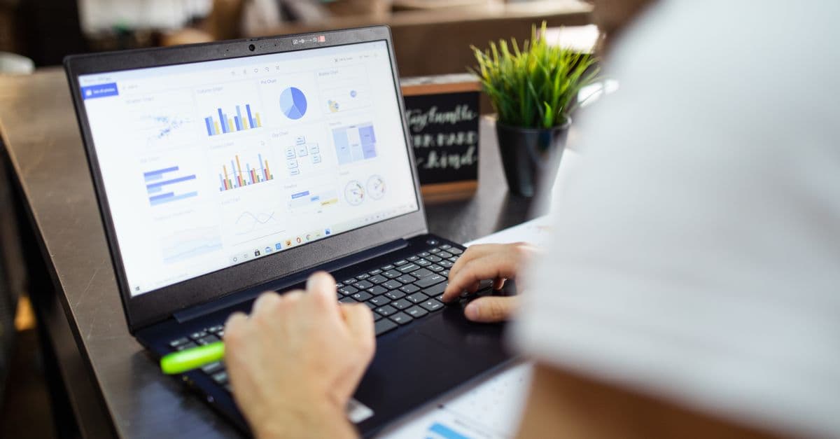 A laptop screen showing business charts and financial analysis