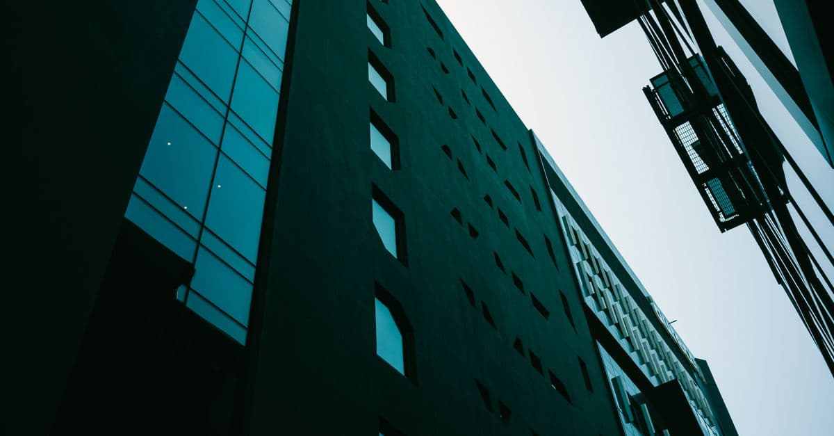 A modern glass office building photographed from a low angle