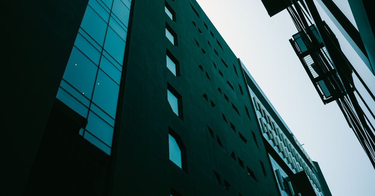 A modern glass office building photographed from a low angle